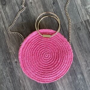 Round, pink straw purse with gold hardware